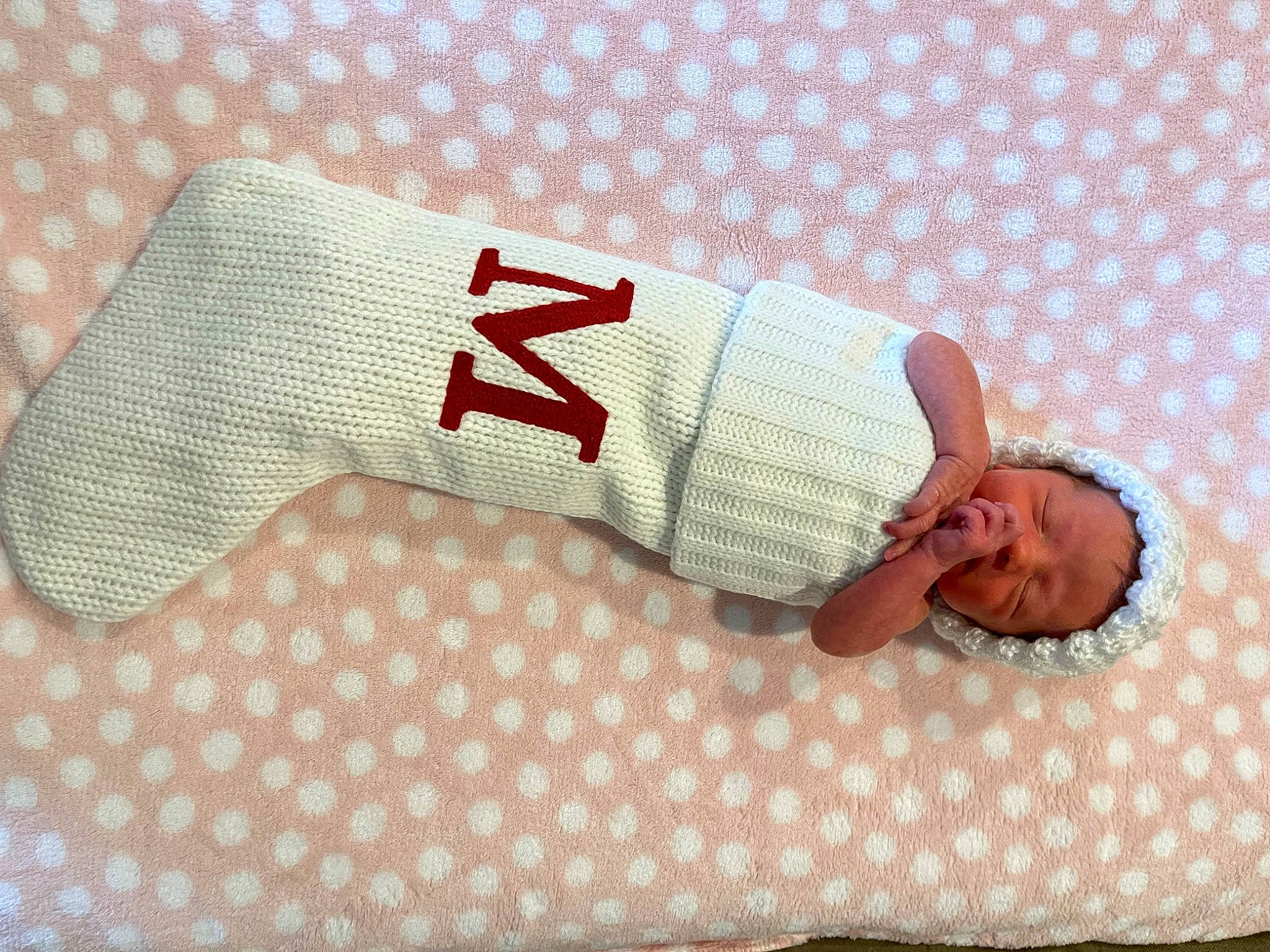 Mara is registered to the contest to win money with this photo: baby_toddler_clothing, bedding, carmine, child, comfort, fashion_accessory, flooring, font, foot, hand, human_leg, knee, leg, linens, pattern, person, product, sleeve, textile, thigh