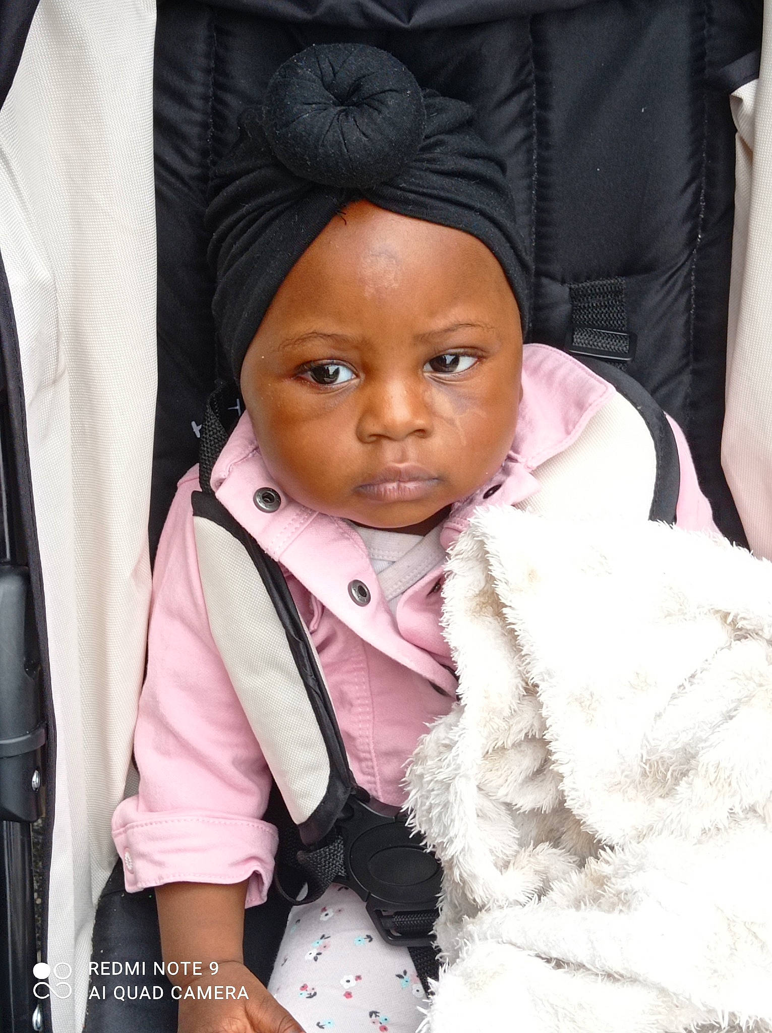 Abibatou participe au concours pour gagner de l'argent avec cette photo : baby, beanie, black_hair, cap, cheek, child, eye, fashion_accessory, fun, fur, happy, head, headwear, knit_cap, magenta, person, purple, scarf, sleeve, street_fashion