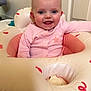 baby, infant, smiling, pink_clothing, inflatable_ring, indoor, child, happy, face, head, person, cute, seated, toy, playtime, young_child, skin, blue_eyes, baby_girl, cozy