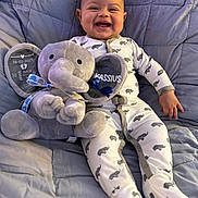 Kassius joined the competition — help win amazing prizes! baby, child, comfort, cozy, cute, elephant, fabric, footed_pajamas, happy, indoor, infant, lying_down, onesie, personalized, plush_toy, portrait, quilt, smiling, soft_toy, toy