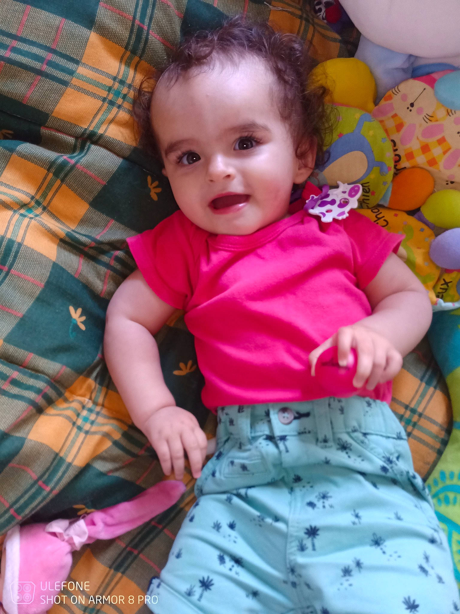 Cassandra participe au concours pour gagner de l'argent avec cette photo : arm, baby, baby_toddler_clothing, cheek, child, comfort, eye, happy, head, linens, pattern, person, pink, plaid, skin, sleeve, smile, t_shirt, tartan, textile