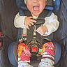 Mya joined the competition — help win amazing prizes! baby, child, car_seat, seatbelt, head_wrap, colorful_clothing, patterned_pants, smiling, happy, infant, footwear, plaid_blanket, indoor, cute, portrait, sitting, secured, young_child, joyful, bright_eyes