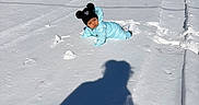 Vega is registered to the contest to win money with this photo: baby, barn, child, cold_weather, daytime, ground, hat, outdoor, person, photography, playful, pom_poms, rural, shadow, sky, snow, snowsuit, sunny, swing, winter_clothing