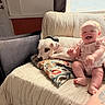 Zoey joined the competition — help win amazing prizes! baby, dog, couch, pillow, indoor, smiling, happy, pet, child, living_room, window, blanket, relaxing, cute, person, seated, comfort, home, animal, friendship