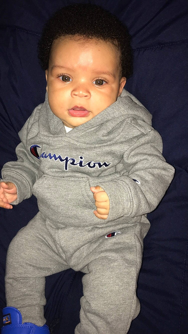 Aaden is registered to the contest to win money with this photo: boy, cheek, child, cool, eye, face, facial_expression, head, human, infant, nose, outerwear, person, product, sitting, skin, smile, standing, toddler, white