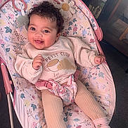 Cami joined the competition — help win amazing prizes! baby, child, smiling, curly_hair, baby_rocker, pink, floral_pattern, socks, leggings, sweater, indoor, happy, person, cute, infant, seat, comfort, playtime, cozy, portrait