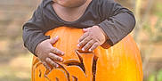 Niko is registered to the contest to win money with this photo: americanfootball, americanfootballball, ball, bodypart, boy, child, face, finger, food, football, hand, head, male, person, photography, plant, produce, pumpkin, squash, vegetable
