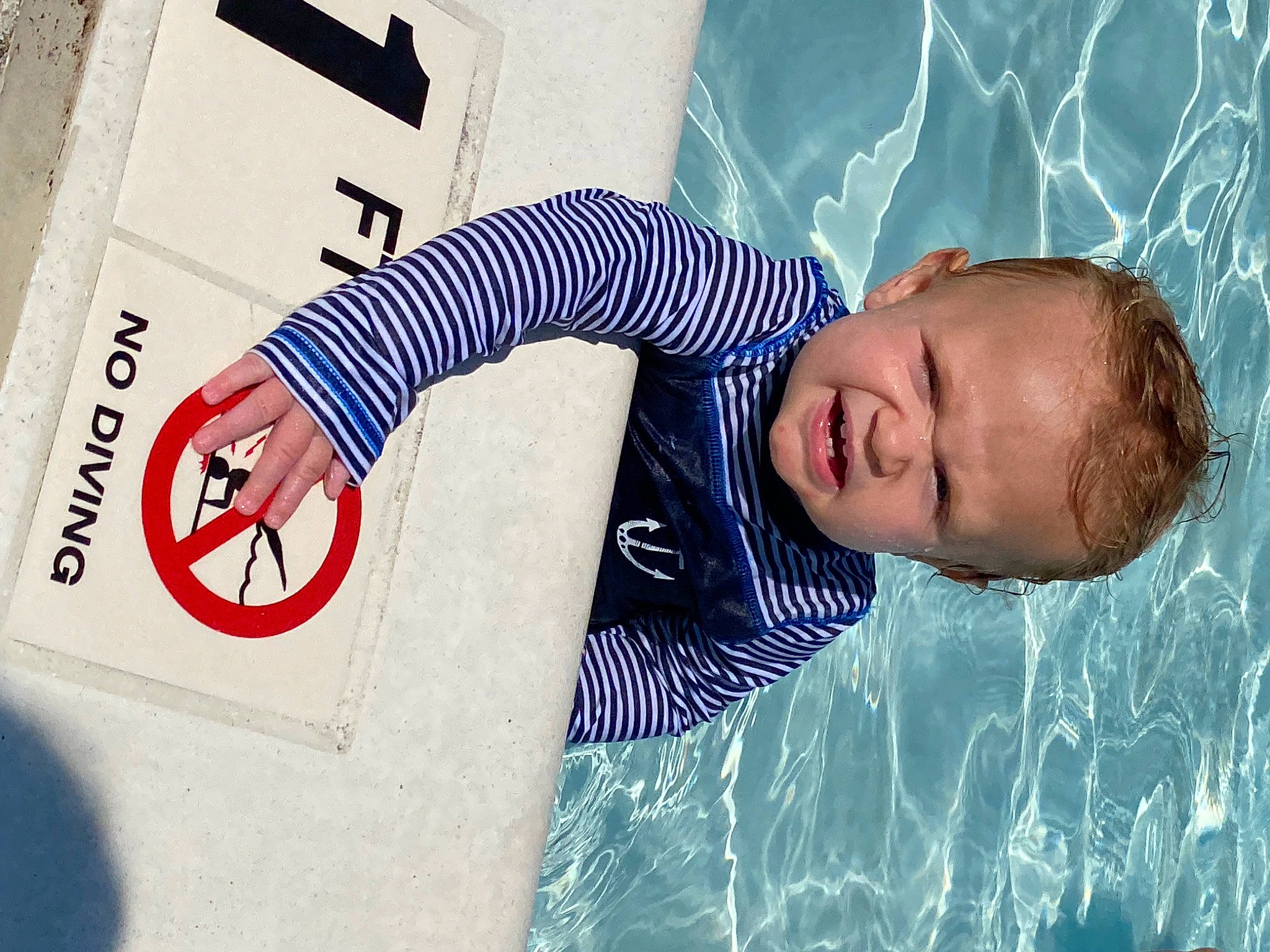 Kolby is registered to the contest to win money with this photo: azure, baby, carmine, child, elbow, electric_blue, font, fun, happy, leisure, number, pattern, people, people_in_nature, person, play, recreation, sleeve, sorrow, t_shirt