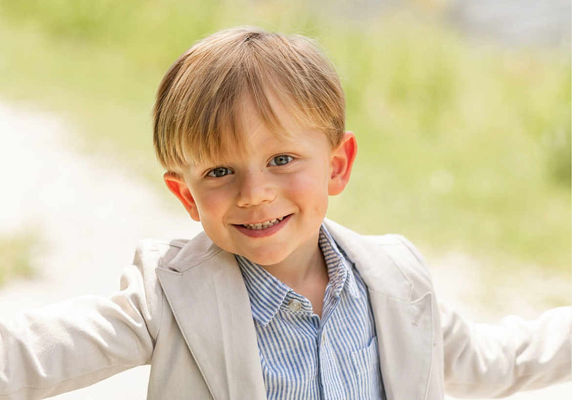 Trevor joined the competition — help win amazing prizes! child, boy, smiling, outdoor, portrait, face, light_blazer, striped_shirt, happy, young, cute, casual_wear, sunlight, natural_light, grass_background, blond_hair, short_hair, arms_outstretched, daytime, closeup