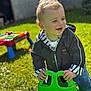Noah participe au concours pour gagner de l'argent avec cette photo : toddler, child, smiling, outdoor, grass, toy, green, jacket, curly_hair, happy, play, sunlight, garden, jeans, person, playground, plastic_toy, daylight, cute, fun
