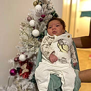 Violetta a rejoint le concours — aidez-le/la à gagner de superbes lots ! baby, infant, winnie_the_pooh, pajamas, clothing, person, face, hands, christmas_tree, ornaments, holiday, indoor, decorations, blurred_background, cozy, cute, child, holding, festive, warm_lighting