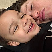 Idris joined the competition — help win amazing prizes! child, young_person, face, smile, close_up, selfie, skin, freckles, acne, affection, joy, casual_clothing, black_shirt, curly_hair, portrait, indoor, head, person, happy, together