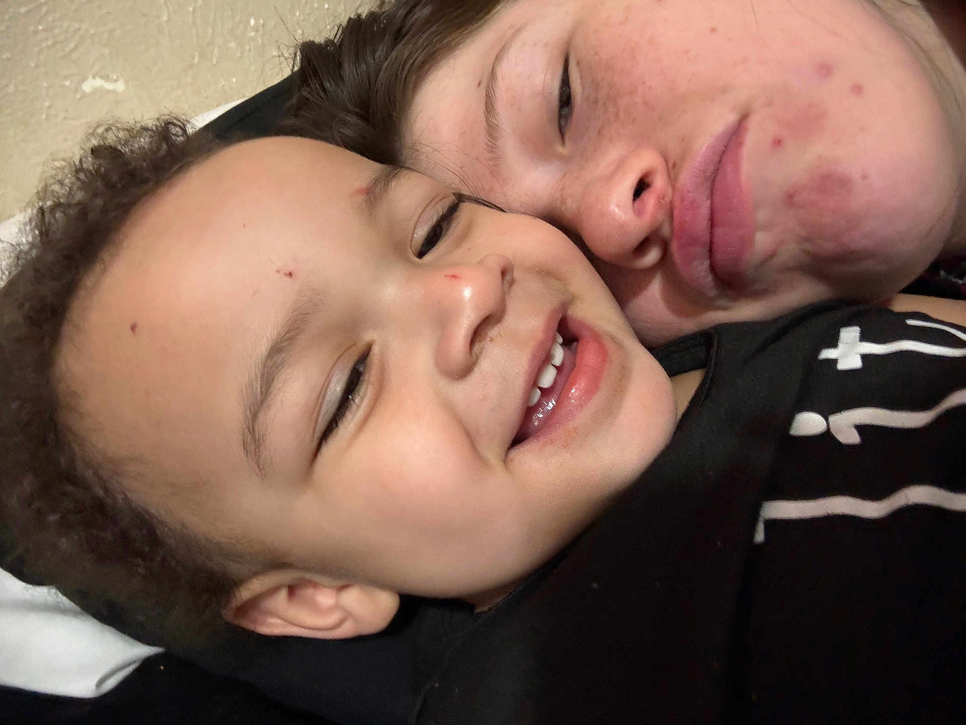 Idris joined the competition — help win amazing prizes! child, young_person, face, smile, close_up, selfie, skin, freckles, acne, affection, joy, casual_clothing, black_shirt, curly_hair, portrait, indoor, head, person, happy, together