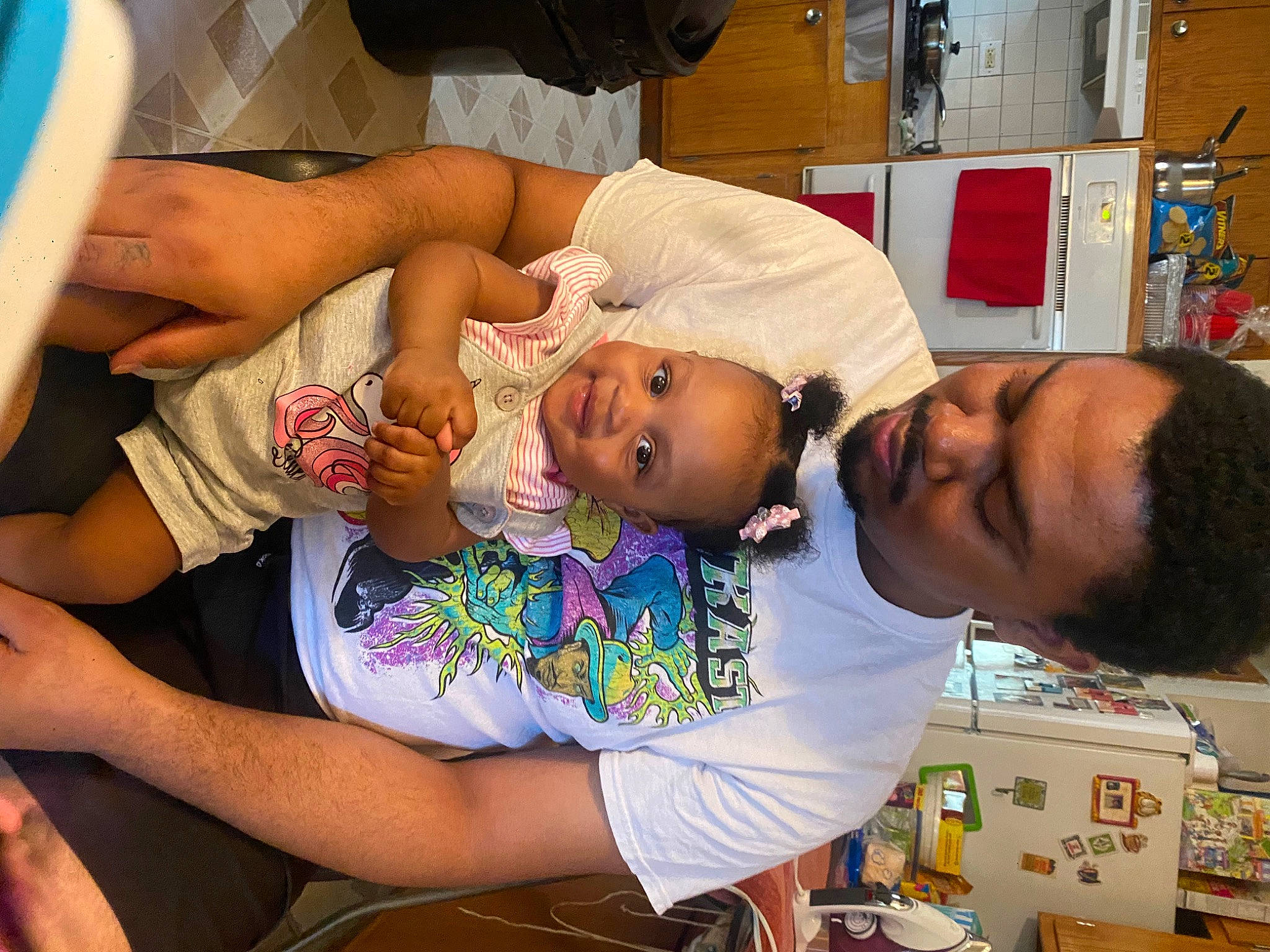 Joy is registered to the contest to win money with this photo: abdomen, baby, chest, child, community, elbow, event, fun, happy, joy, leisure, mouth, person, room, service, sharing, shorts, smile, t_shirt, thigh