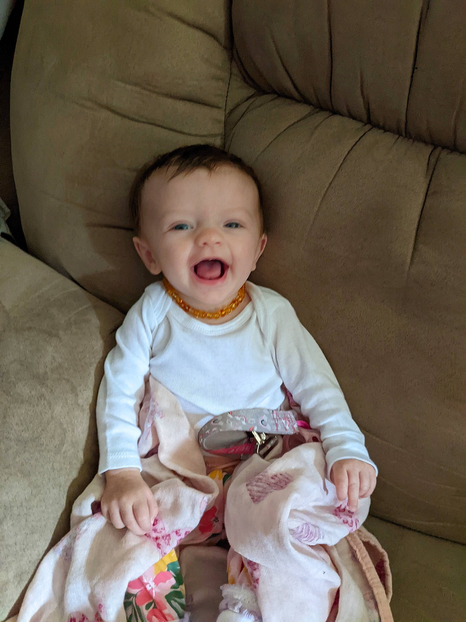 Lakeleigh joined the competition — help win amazing prizes! baby, baby_toddler_clothing, cheek, child, comfort, couch, dress, face, happy, head, linens, peach, person, product, sitting, skin, sleeve, smile, textile, toddler