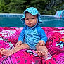 baby, child, pool, inflatable, float, swimsuit, hat, blue, pink, water, outdoor, summer, pucker, funny_face, toddler, toy, greenery, nature, sitting, cute