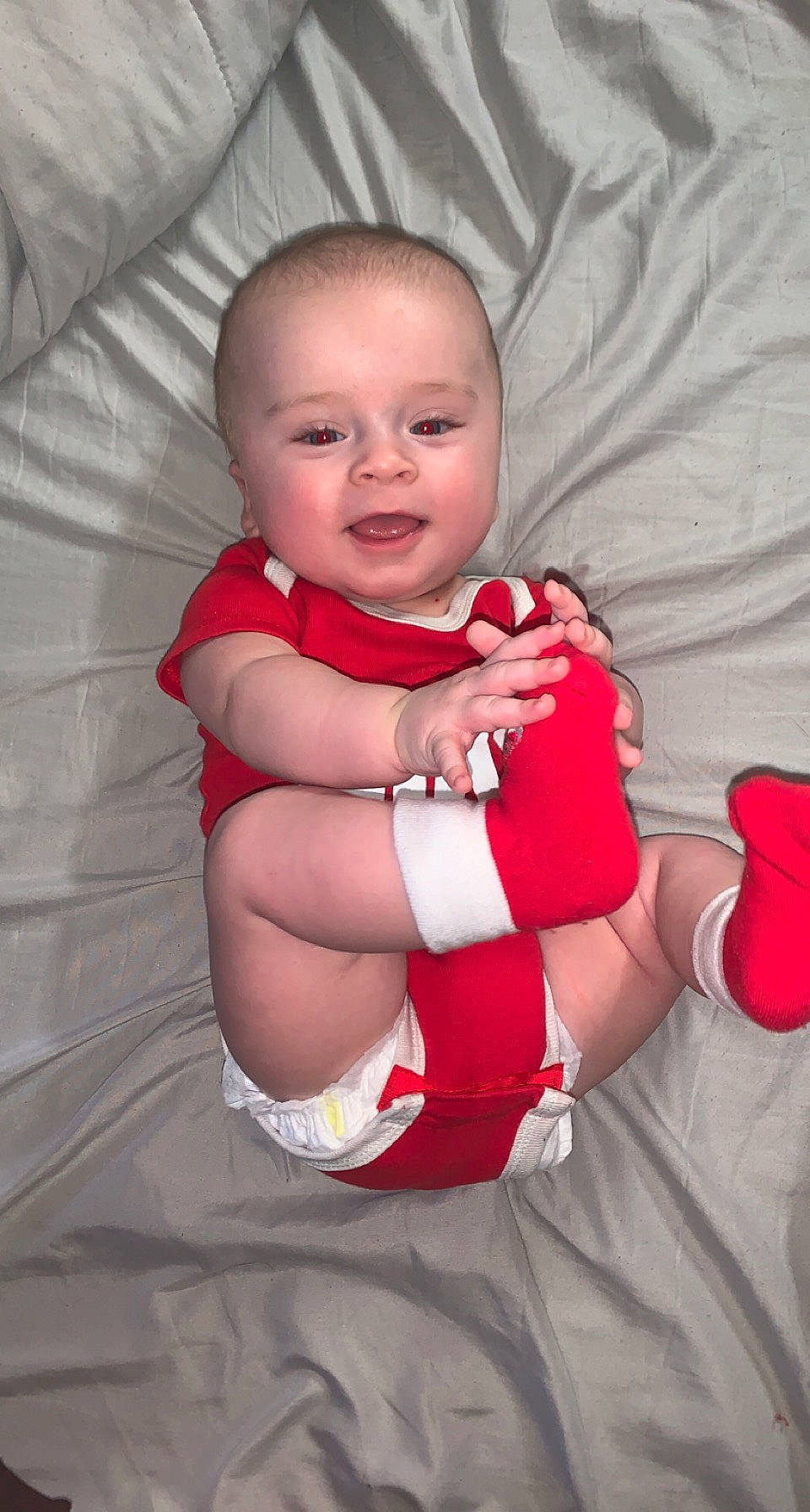 Gracen is registered to the contest to win money with this photo: baby, baby_toddler_clothing, comfort, face, facial_expression, finger, flash_photography, gesture, happy, head, lip, mouth, person, pink, skin, sleeve, smile, stomach, textile, thumb