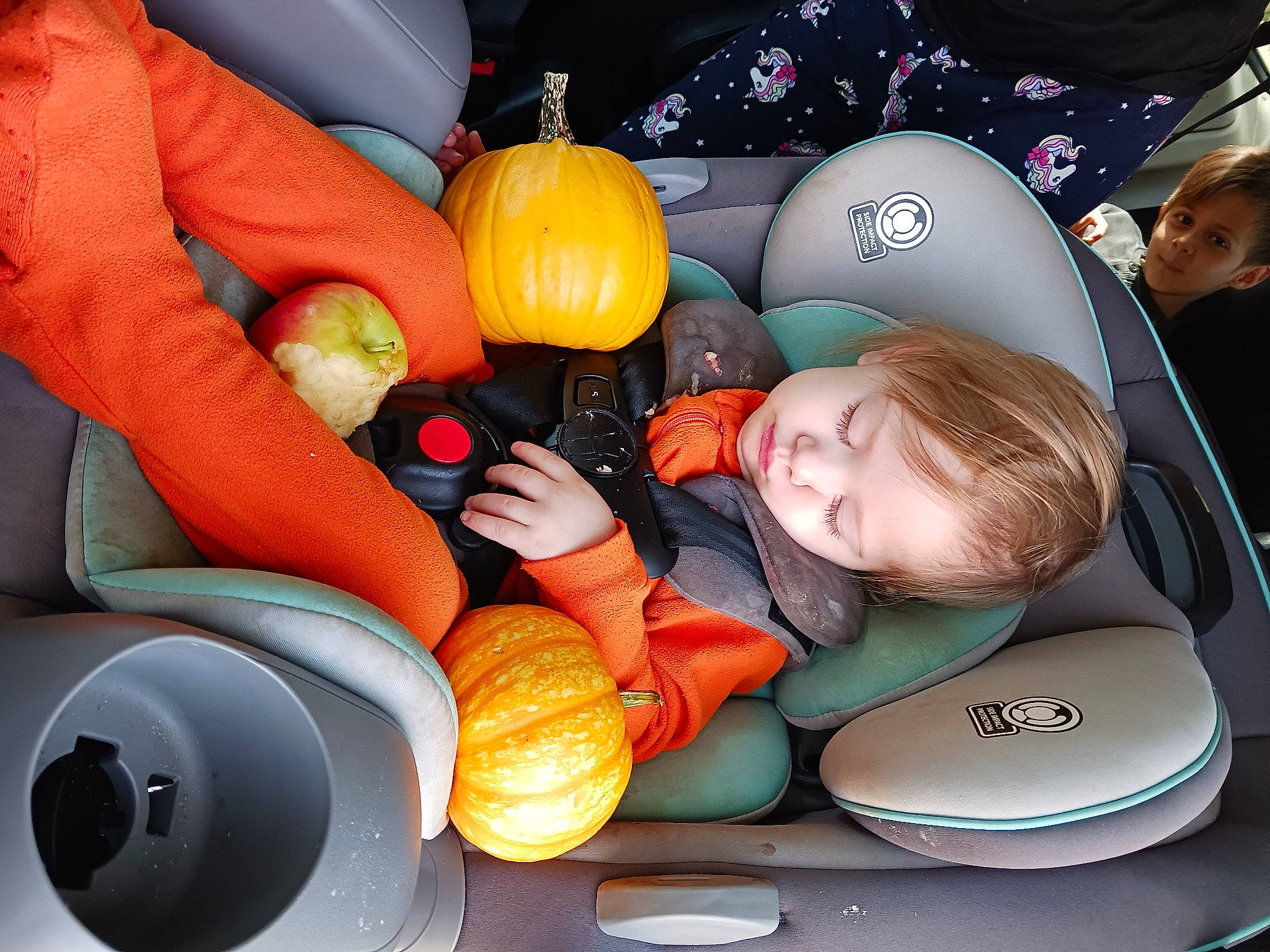 Kinsley is registered to the contest to win money with this photo: automotive_design, ball, calabaza, car_seat, child, comfort, cucurbita, fun, gourd, motor_vehicle, orange, person, plant, product, pumpkin, squash, steering_wheel, toddler, vegetable, vehicle_door