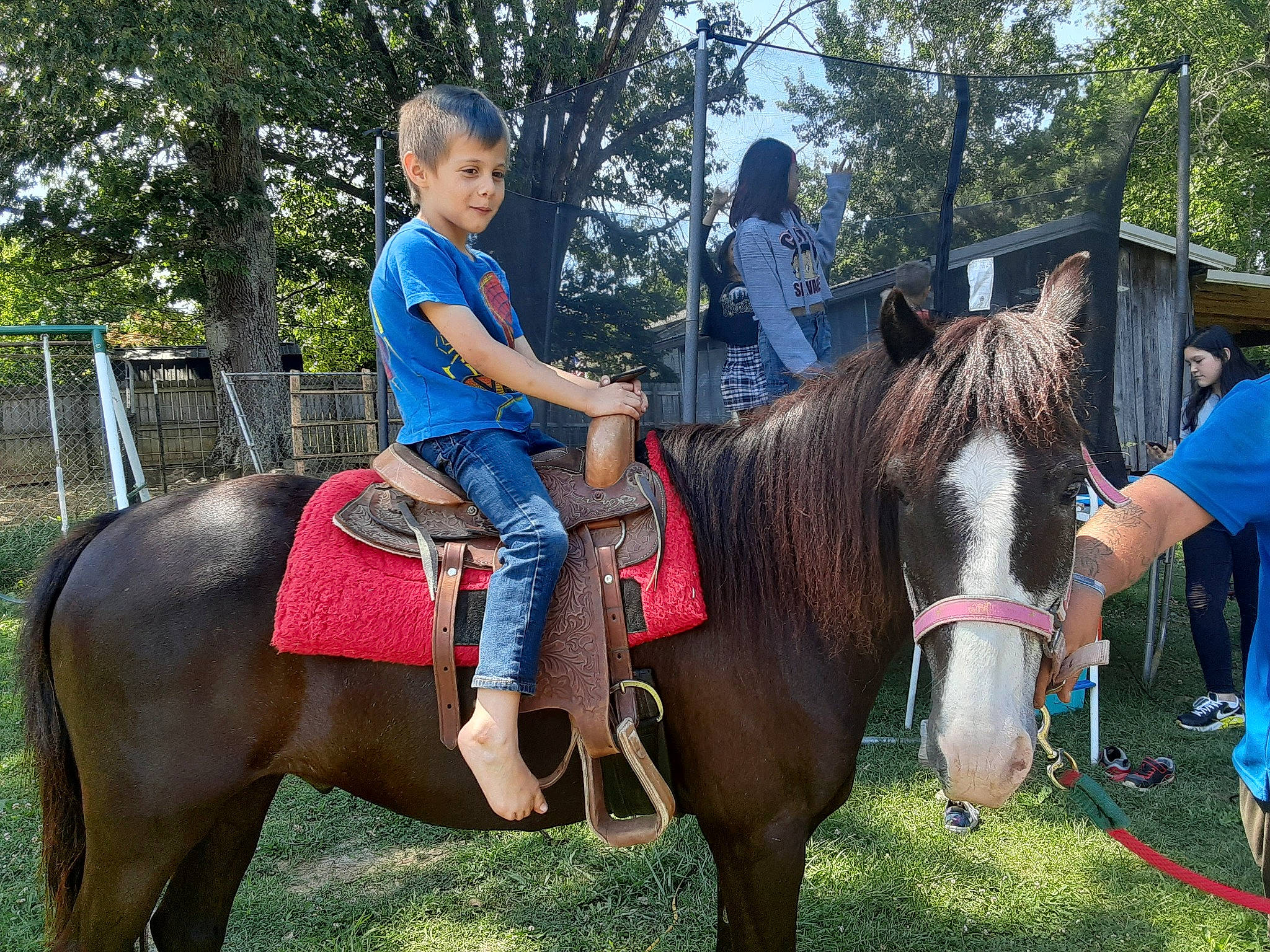 Michael is registered to the contest to win money with this photo: bit, bridle, equestrian_sport, equestrianism, grass, horse, horse_supplies, horse_tack, landscape, mammal, mane, outdoor_recreation, pack_animal, person, rein, saddle, shorts, t_shirt, tree, vertebrate