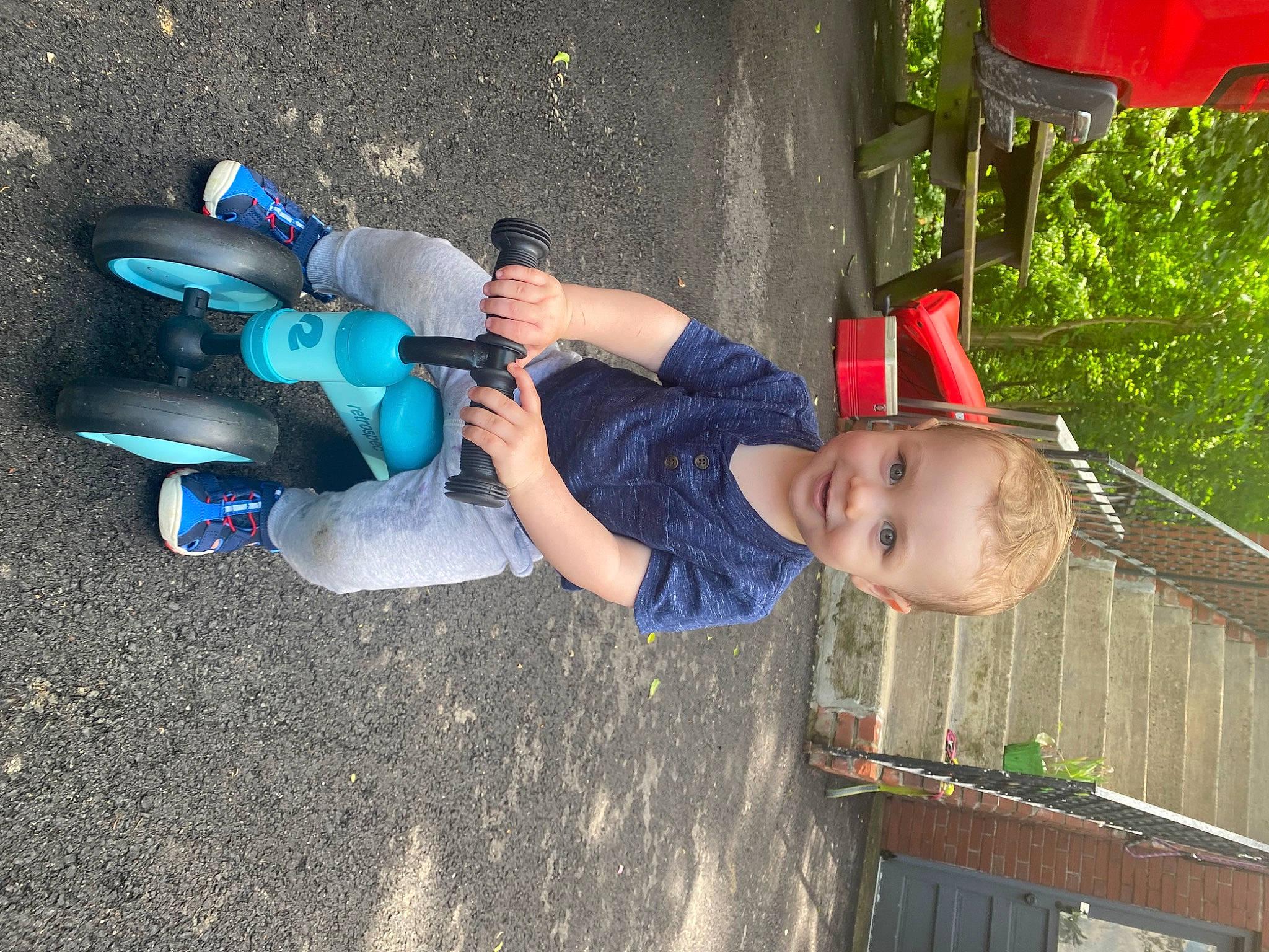 Brady is registered to the contest to win money with this photo: ankle, asphalt, child, city, electric_blue, foot, fun, grass, human_leg, joy, leisure, nail, person, plastic, play, recreation, soil, t_shirt, thigh, toddler