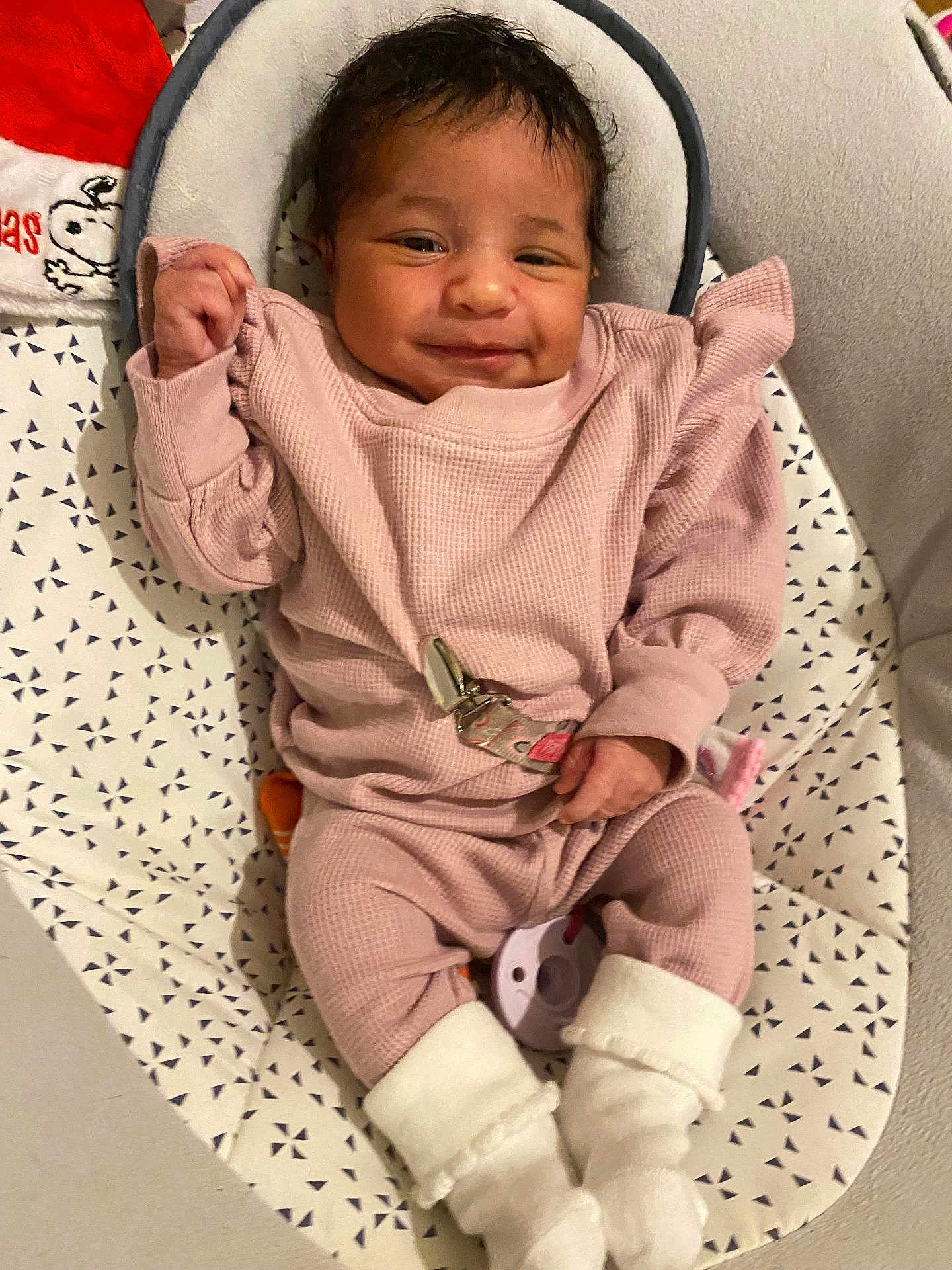 Tyleah joined the competition — help win amazing prizes! baby, infant, smile, pink_clothing, white_booties, baby_seat, patterned_cover, happy, cute, child, newborn, indoor, portrait, soft_fabric, cozy, small_hands, relaxed, young_child, face, person