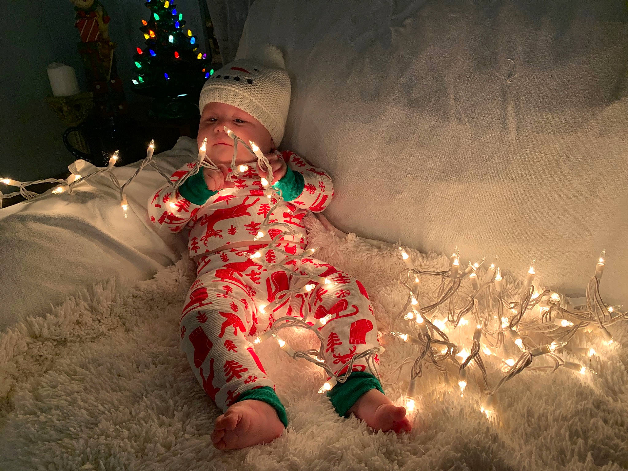 Kayzleigh joined the competition — help win amazing prizes! baby, baby_toddler_clothing, christmas, christmas_decoration, christmas_eve, christmas_lights, christmas_ornament, christmas_tree, darkness, event, fun, happy, headwear, holiday, human_body, lap, lighting, person, sitting, toddler