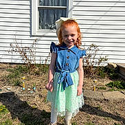 Natalie joined the competition — help win amazing prizes! boots, bow, child, daytime, denim, dress, girl, grass, house, outdoor, plants, portrait, red_hair, shadow, skirt, smiling, standing, sunlight, tights, window