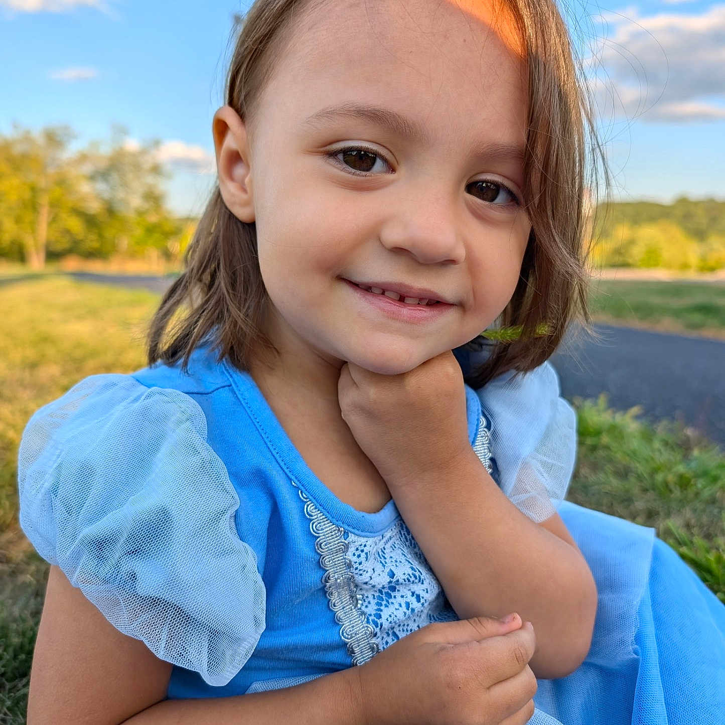 Elora joined the competition — help win amazing prizes! blue_dress, casual, child, closeup, cute, daylight, face, grass, hand, happy, innocence, nature, outdoor, person, portrait, puffy_sleeves, scenic, smile, sunlight, young_girl