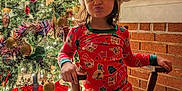 Elora joined the competition — help win amazing prizes! brick_wall, carpet, celebration, child, christmas_tree, cute, decorations, festive, holiday, holiday_spirit, indoor, lighting, ornaments, pajamas, playful, rocking_chair, santa_hat, smiling, tinsel, window_blinds