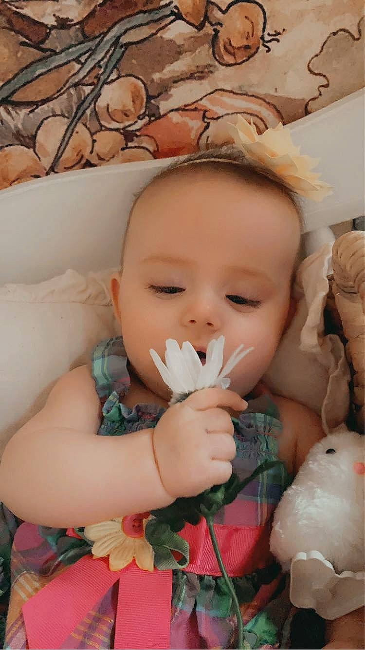 Makenzie is registered to the contest to win money with this photo: baby_toddler_clothing, cheek, chin, doll, eye, eyelash, face, finger, happy, head, human_body, iris, lip, mouth, ornament, person, pink, skin, textile, toddler