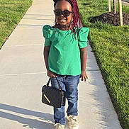 Camila is registered to the contest to win money with this photo: child, city, clothing, face, female, footwear, girl, grass, head, jeans, pants, path, person, photography, plant, portrait, road, shoe, sidewalk, t_shirt