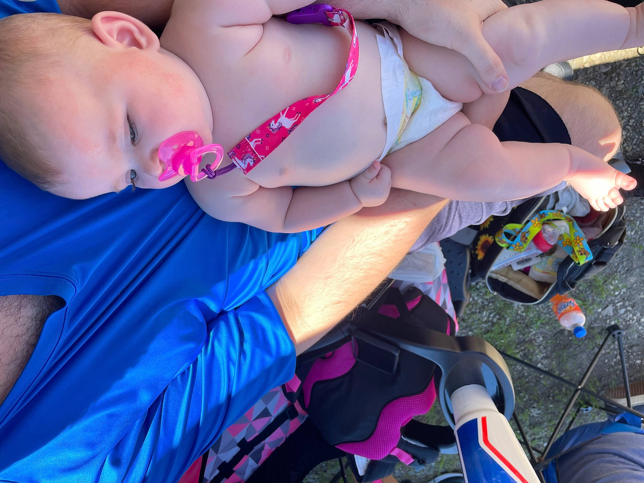 Madi is registered to the contest to win money with this photo: arm, baby, blue, child, cool, electric_blue, eyewear, finger, fun, grass, hand, happy, human_body, human_leg, leisure, nail, person, pink, shorts, swimwear