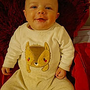 Noha a rejoint le concours — aidez-le/la à gagner de superbes lots ! baby, infant, smile, face, clothing, pajamas, fox_design, red_pillow, red_blanket, indoor, cute, child, young, soft_texture, seated, happy, portrait, cozy, warm_colors, person