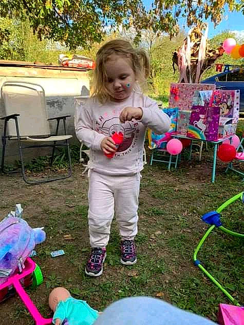 Lilly is registered to the contest to win money with this photo: chair, child, city, event, fun, grass, happy, leisure, people, person, photograph, pink, plant, play, public_space, recreation, snapshot, summer, toddler, toy