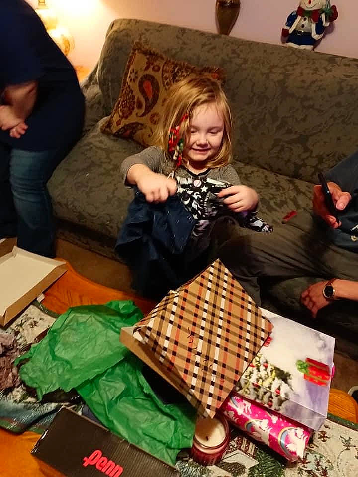 Lilly is registered to the contest to win money with this photo: bag, basket, box, comfort, couch, event, fun, holiday, joy, lamp, lap, living_room, luggage_and_bags, pattern, person, picture_frame, present, recreation, room, sharing