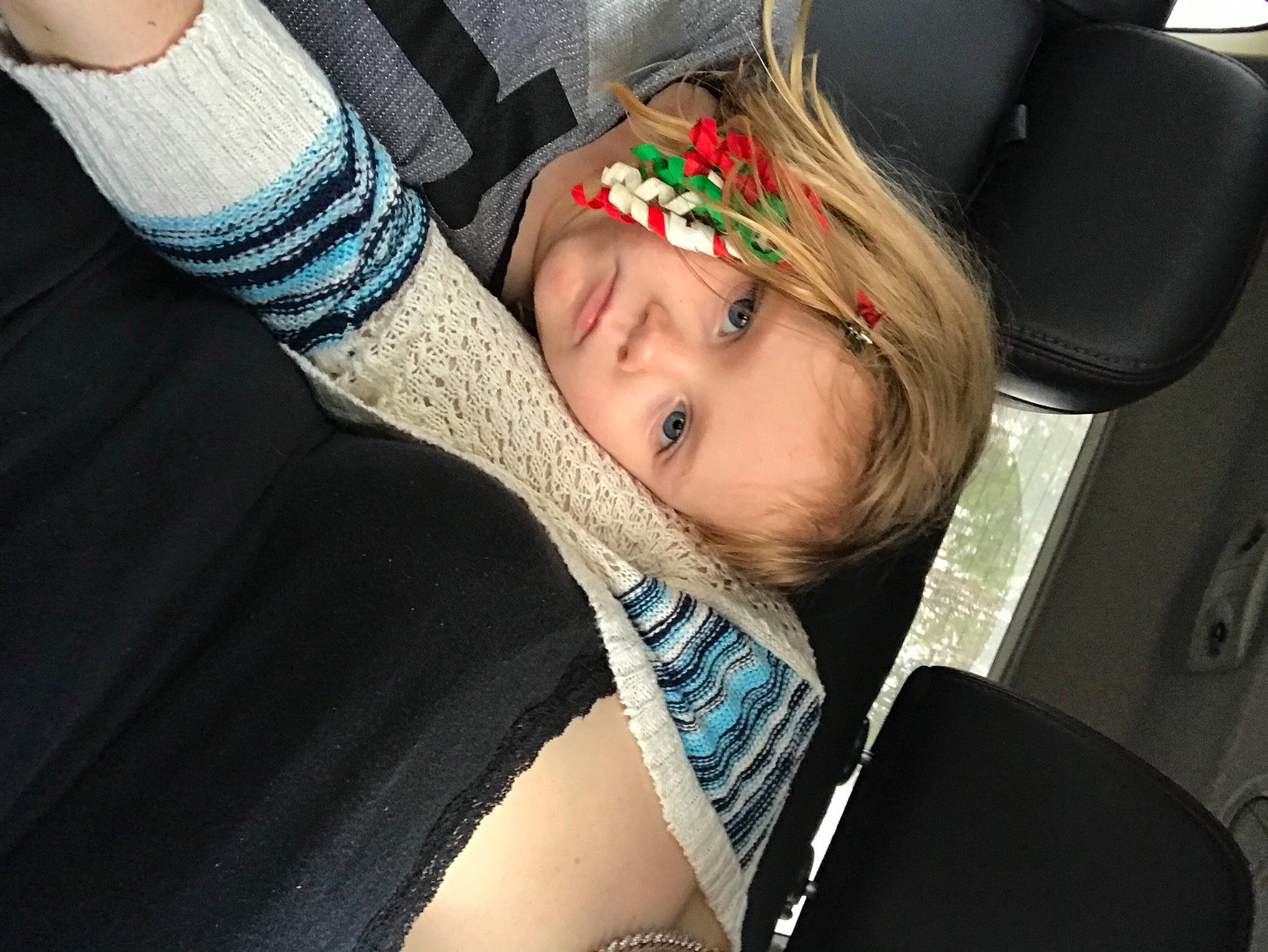 Lilly is registered to the contest to win money with this photo: auto_part, automotive_design, blond, car_seat, car_seat_cover, child, comfort, eyebrow, family_car, fashion_accessory, finger, fun, happy, hat, human_body, jewellery, person, sitting, smile, toddler