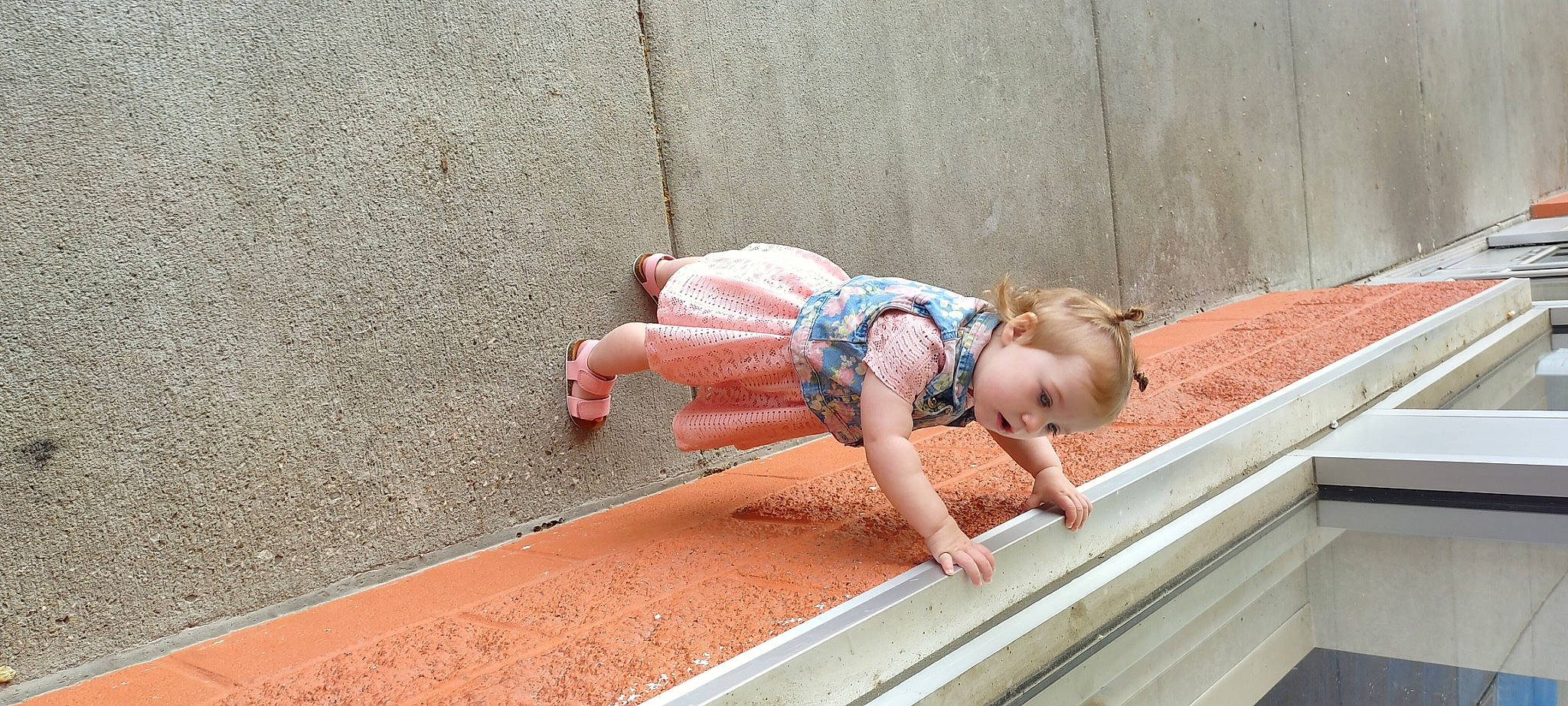 Adelina is registered to the contest to win money with this photo: asphalt, baby, barefoot, child, flooring, foot, fun, grass, hand, human_leg, leg, leisure, line, person, road_surface, sidewalk, sitting, thigh, toddler, water