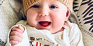 Cayson joined the competition — help win amazing prizes! baby, smiling, knitted_hat, lion_hat, thanksgiving, festive_shirt, infant, cute, happy, portrait, child, clothing, patterned_cushion, indoor, celebration, cozy, headwear, baby_gesture, joyful, closeup