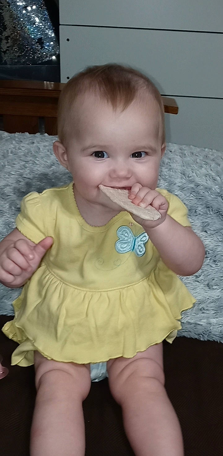 Arriah is registered to the contest to win money with this photo: arm, baby_toddler_clothing, cheek, eye, face, facial_expression, finger, hair, hand, head, human_body, iris, joy, mouth, neck, nose, person, product, skin, sleeve