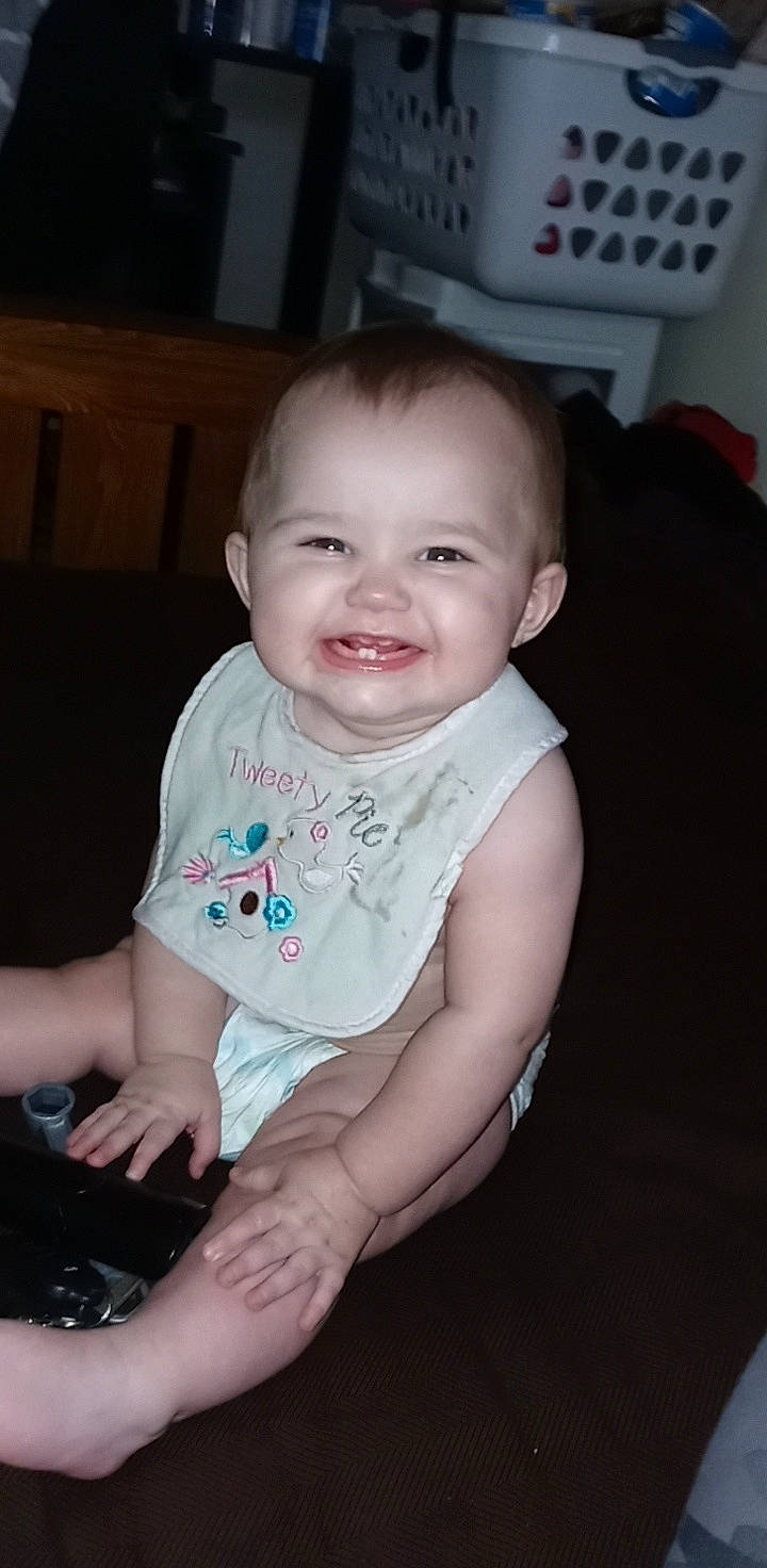 Arriah is registered to the contest to win money with this photo: baby, baby_toddler_clothing, cheek, computer_keyboard, eye, finger, flash_photography, flooring, fun, hand, happy, iris, joy, mouth, nose, person, sitting, skin, sleeve, smile