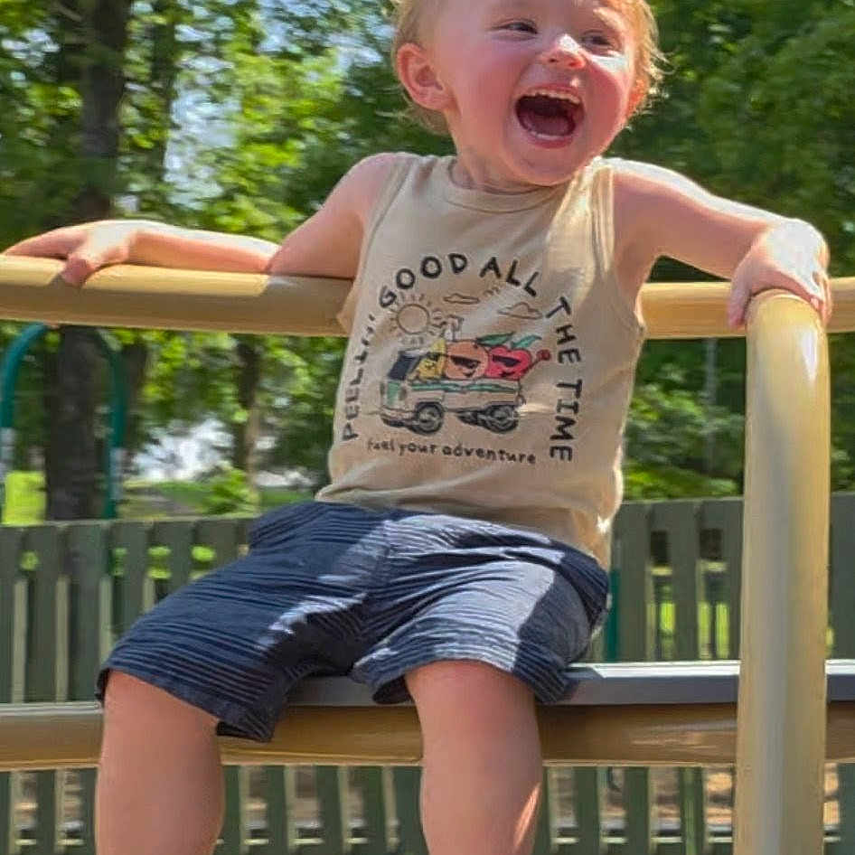 Myles joined the competition — help win amazing prizes! child, toddler, laughing, playground, outdoor, trees, fence, sunny, happy, shorts, tank_top, sandals, summer, play, fun, metal_bars, park, smile, youth, nature