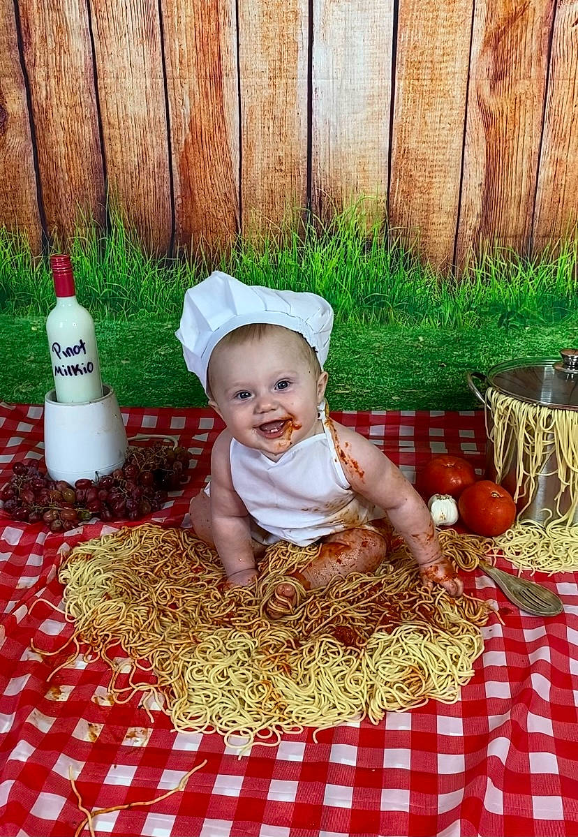 Ava Jane is registered to the contest to win money with this photo: baby, baby_toddler_clothing, basket, cap, child, costume_hat, cuisine, fence, flooring, grass, happy, hat, joy, linens, pattern, people_in_nature, person, sitting, smile, storage_basket