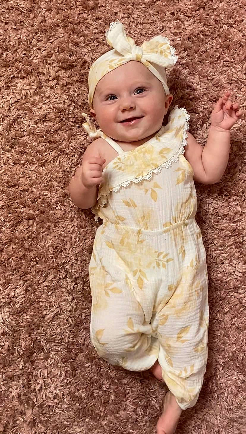 Ava Jane is registered to the contest to win money with this photo: baby, baby_laughing, baby_toddler_clothing, cap, child, facial_expression, fashion_accessory, flash_photography, fun, grass, hair_accessory, happy, headband, headpiece, headwear, joy, people_in_nature, person, skin, sleeve