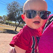 Wyatt joined the competition — help win amazing prizes! baby, child, sunglasses, red_shirt, outdoor, sunny, blue_sky, tree, person, hand, smiling, happy, portrait, casual_clothing, daylight, holding, closeup, head, face, nature