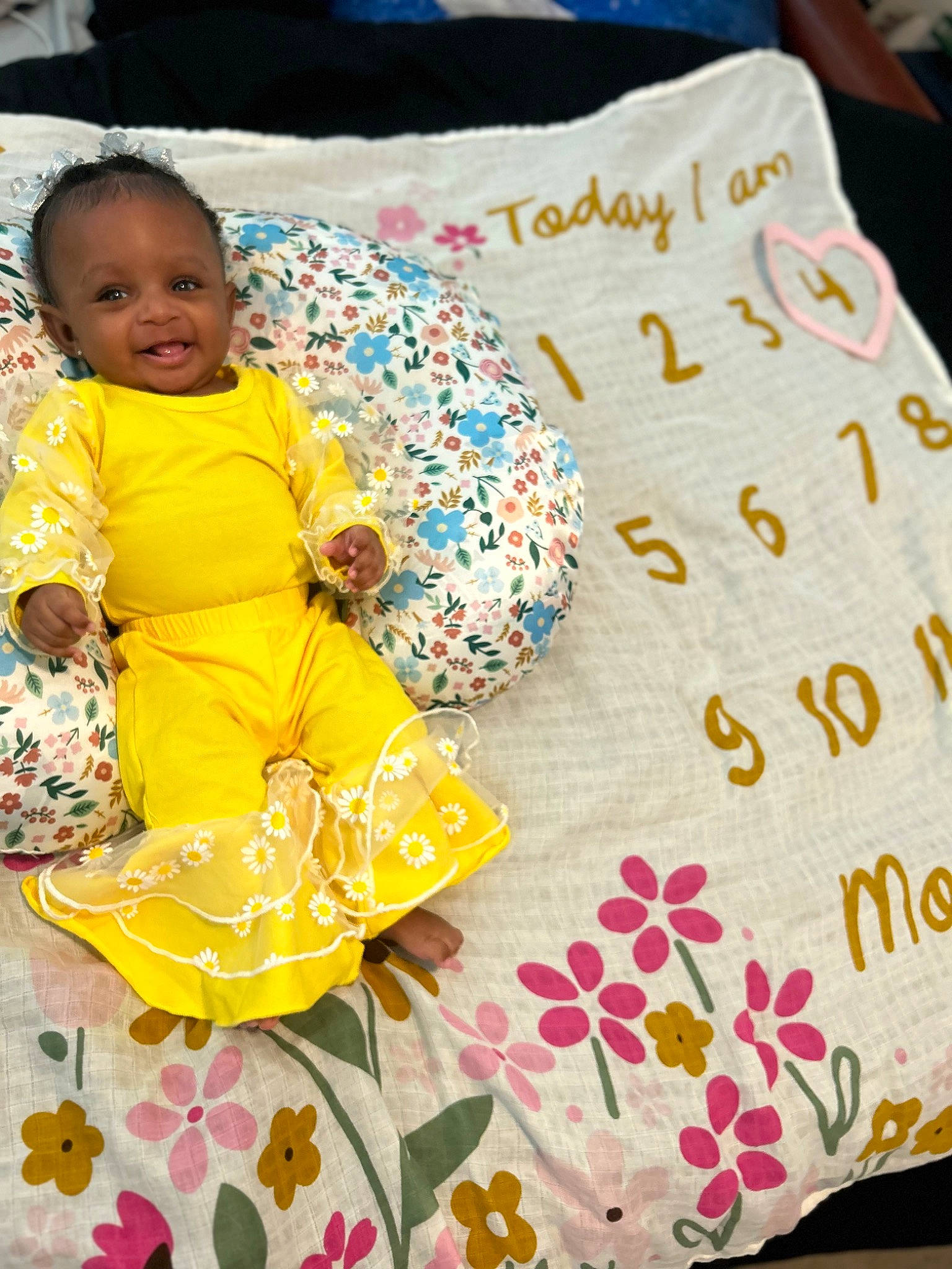 Mariah joined the competition — help win amazing prizes! baby, baby_toddler_clothing, bedding, child, comfort, couch, cushion, face, happy, joy, linens, mammal, pattern, person, room, sleeve, smile, t_shirt, textile, throw_pillow