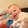 Kaelahni joined the competition — help win amazing prizes! baby, bed, blanket, child, closeup, comfort, cozy, cute, face, happy, head, indoor, infant, person, portrait, skin, smile, soft, white_clothing, young