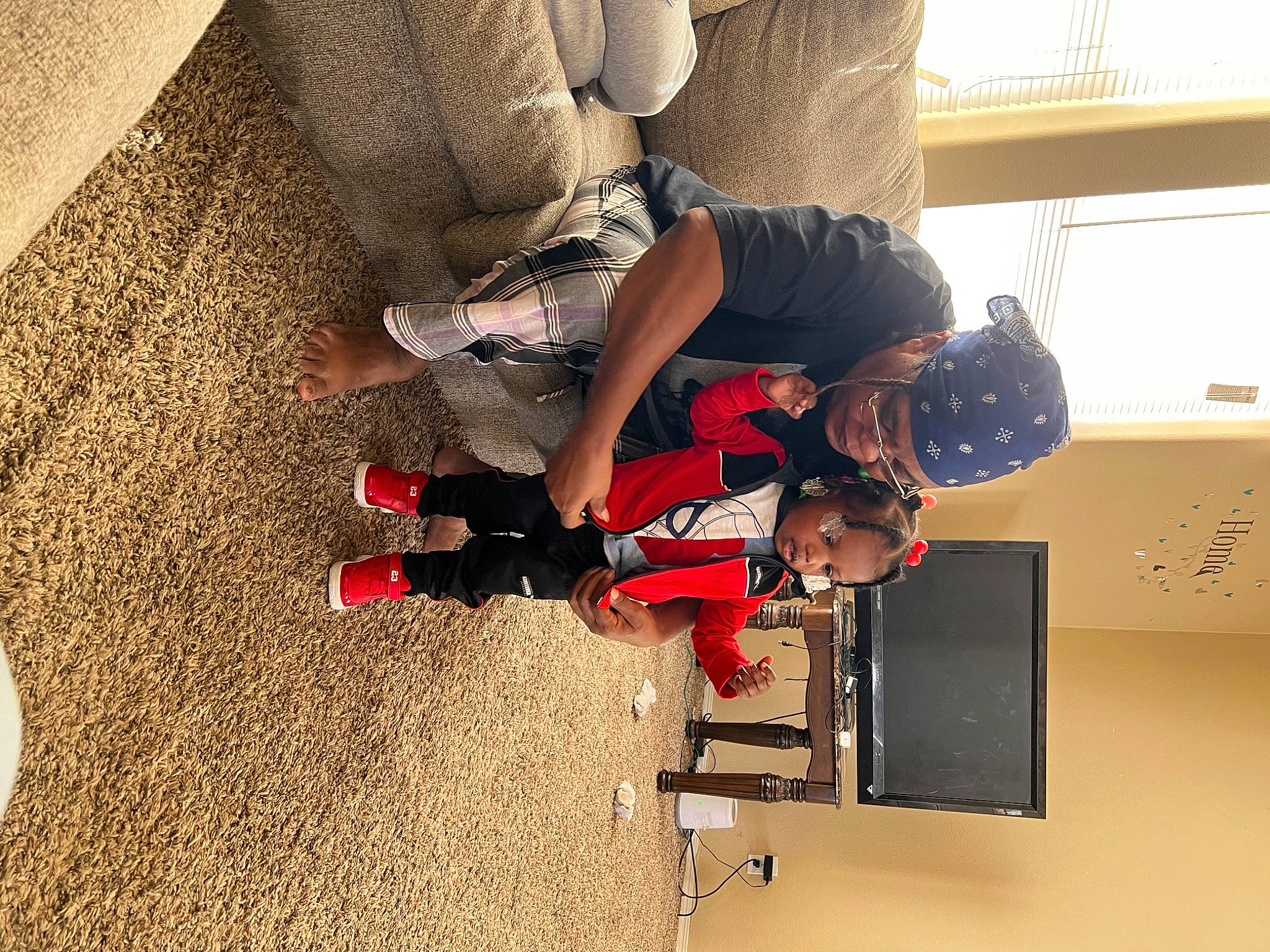 Aveay is registered to the contest to win money with this photo: carmine, child, comfort, elbow, floor, flooring, footwear, fun, hardwood, headwear, human_body, human_leg, knee, machine, person, room, sleeve, sportswear, t_shirt, thigh