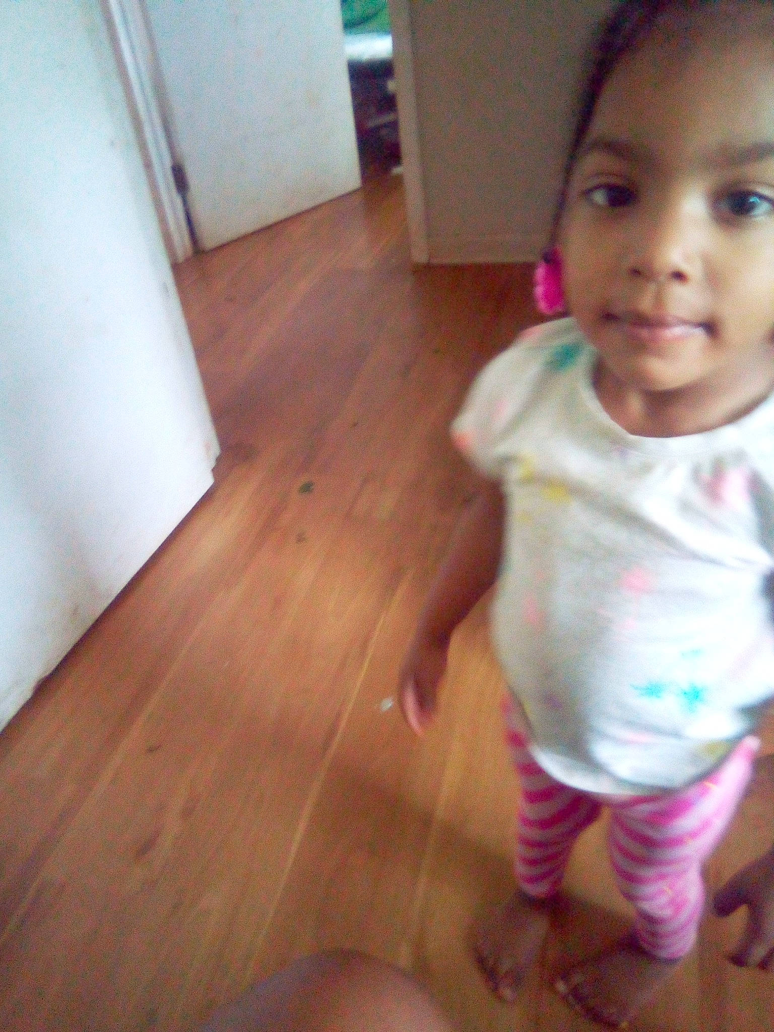 Ganiya is registered to the contest to win money with this photo: baby, cheek, child, face, floor, flooring, hardwood, lip, nose, person, play, skin, smile, standing, toddler, wood