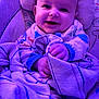 baby, smiling, blanket, pajamas, infant, face, hands, cozy, purple_light, cute, child, portrait, indoors, seat, comfort, soft, happy, expression, closeup, relaxing