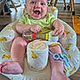 Louka participe au concours pour gagner de l'argent avec cette photo : baby, infant, smiling, happy, child, toy, colorful, indoor, seat, giraffe_pattern, flooring, wooden_floor, furniture, legs, feet, clothing, playful, person, closeup, cute